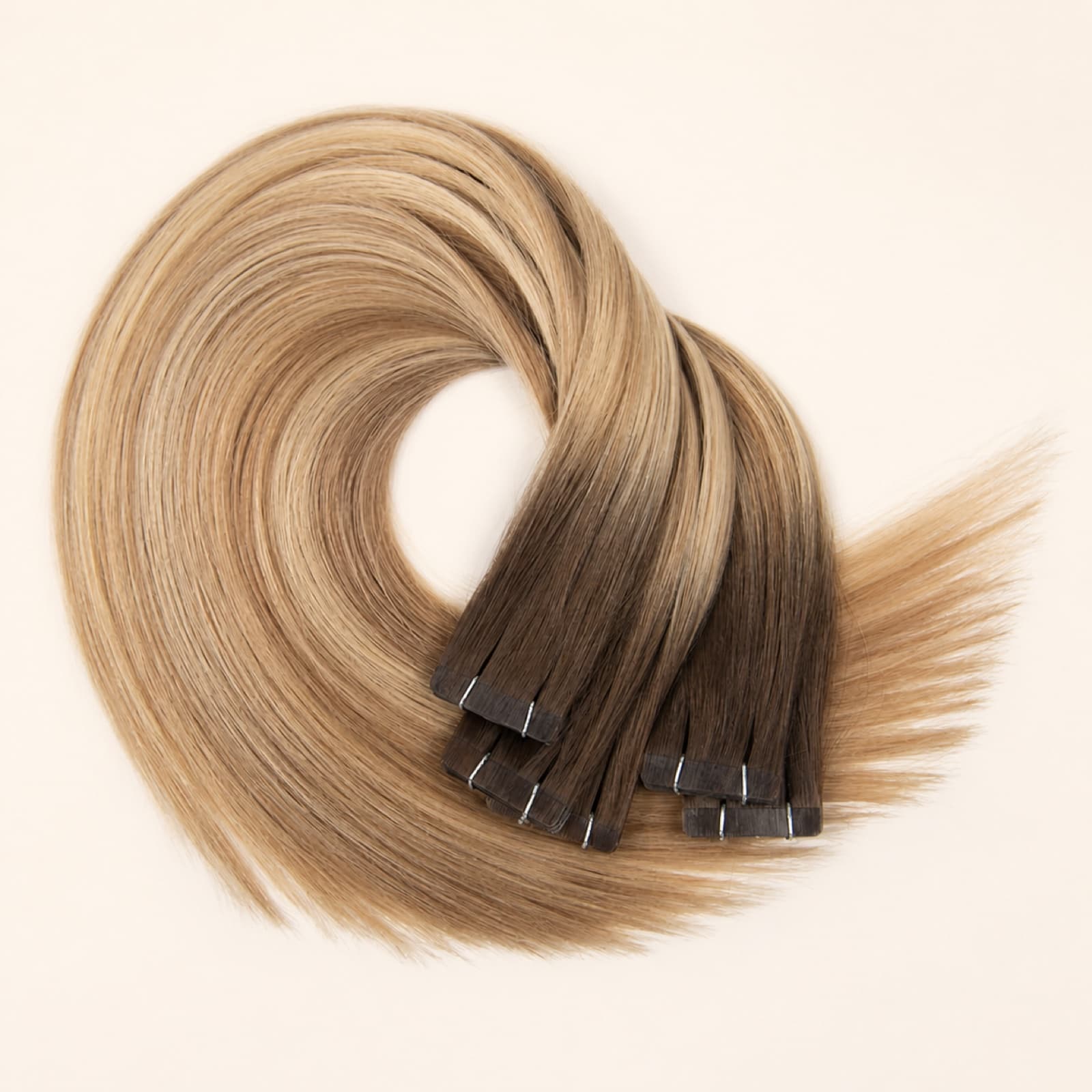 Blonde and brunette tape-in human hair extensions